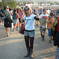 Festivals on a budget - how to save money at festivals - Crystal posing in front of the Glastonbury Festival crowd